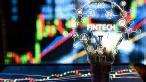 Light bulb on tablet and stock graph and business technology icon with abstract electronic circuit background.  the best fintech stocks to buy.  The best Fintech stocks to buy